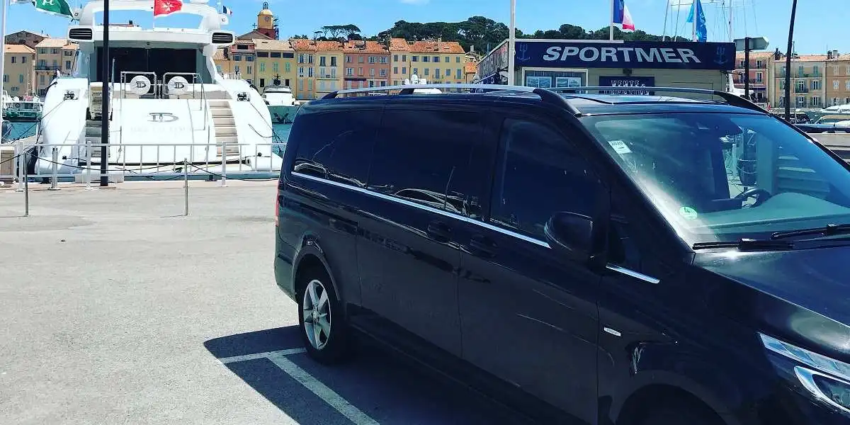 Mercedes V class van parked in front of a pleasure boat in the old port of Saint Tropez